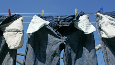 A person air drying a pair of jeans