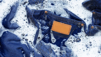 A person washing a pair of jeans 