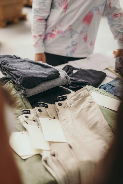 A table with a few Skinny jeans laying on it